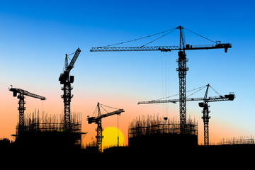 Crane and building construction site at sunset