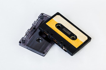 Obraz premium Old audio cassette isolated on white background. Historical records sound on a magnetic tape. Place for your text.