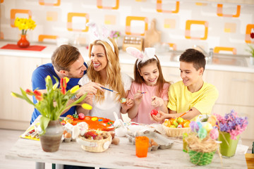 Family together coloring Easter eggs
