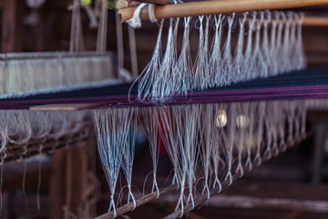 Abstract background of thread on bobbin prepared for weaving and making clothes.