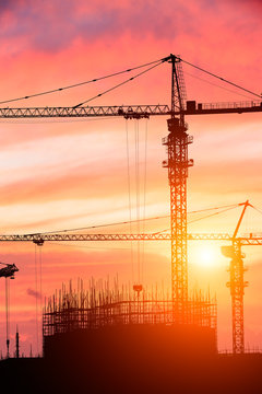 Crane And Building Construction Site At Sunset