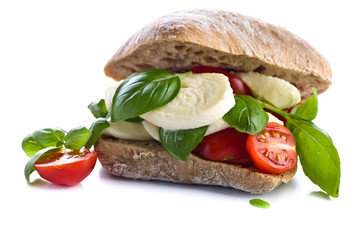 Ciabatta with mozzarella, tomato and basil isolated on white