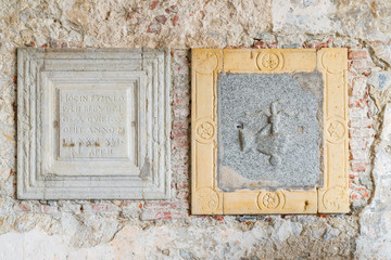 Hermitage of Santa Caterina del Sasso (XIII century) on lake Maggiore, Italy. Detail of two tombstones of the sixteenth century, placed in the portico of the church of St. Catherine