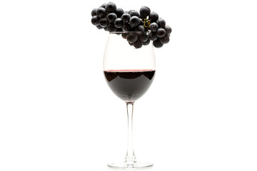 Glass of red wine and grapes isolated on white background