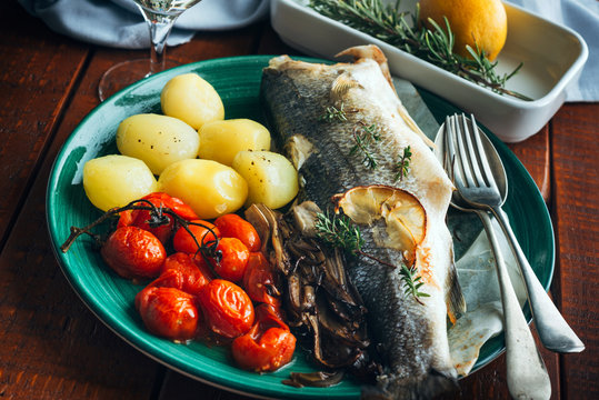 The sea bass baked with potatoes and tomatoes