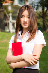 Fototapeta premium Portrait of thai adult student university uniform beautiful girl relax and smile