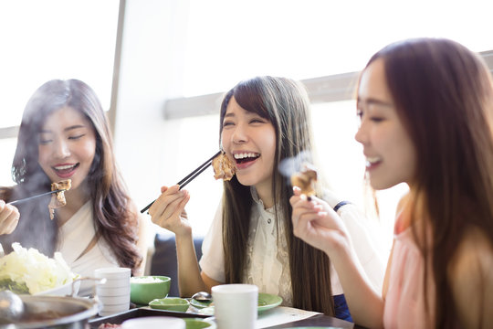 happy young Women group  Eating hot pot
