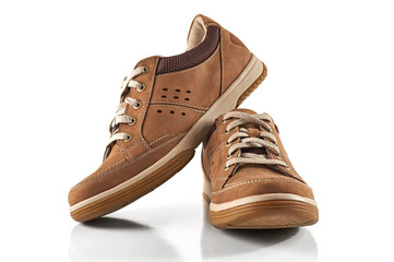 Pair of men's shoes front view. Brown leather sneakers isolated on white background.