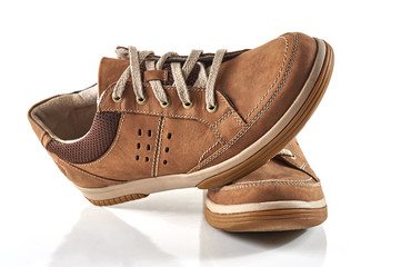 Pair of men's shoes front view. Brown leather sneakers isolated on white background.