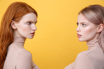 Side view picture of angry young two ladies