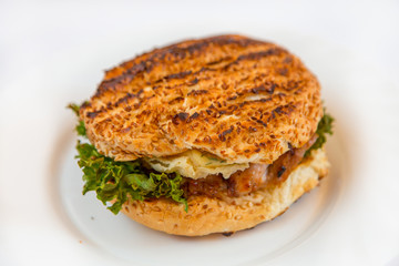 Double cheeseburger on a plate on a white background isolated
