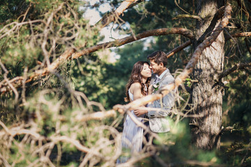 Kissing newlyweds couple. Outdoors  wedding ceremony.