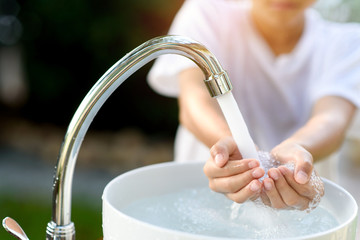 Faucet water and hand