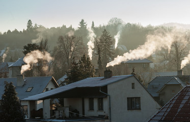 Smoking chimney smoke pollution, small house town in Europe - obrazy, fototapety, plakaty