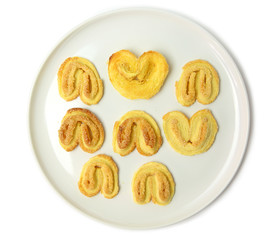 Biscuits on white plate against white background