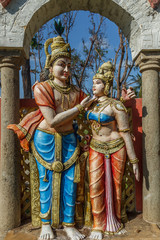 Fototapeta premium Narrow view of an ancient colorful sculpture of a men, seen talking with a women, Chennai, Tamil nadu, India, Jan 29 2017