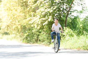 Obraz premium Young boy ride bicycle