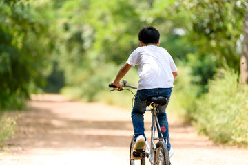 Fototapeta na wymiar Young boy ride bicycle
