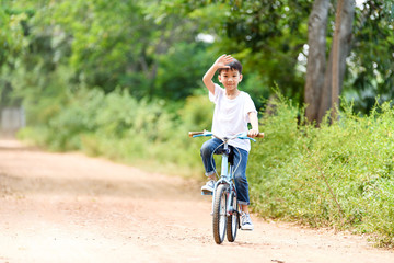 Naklejka premium Young boy ride bicycle