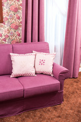 bright purple cushions on the sofa