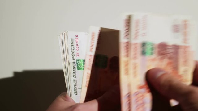 Unrecognizable person counting russian roubles money closeup