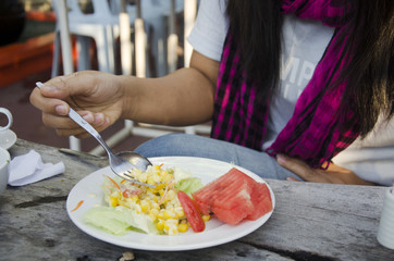 Asian thai woman eating breakfast vegetable and fruits salad