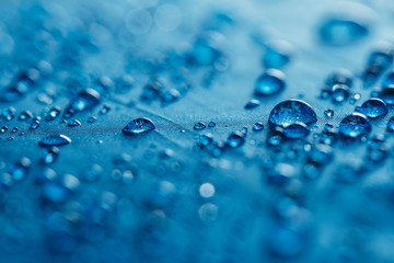 Rain Water droplets on blue  waterproof fabric