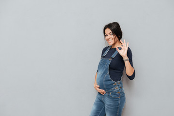 Happy pregnant lady make okay gesture