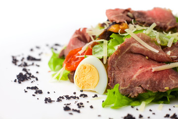 meat salad with roast beef, mushrooms, vegetables and cheese on white background, isolated