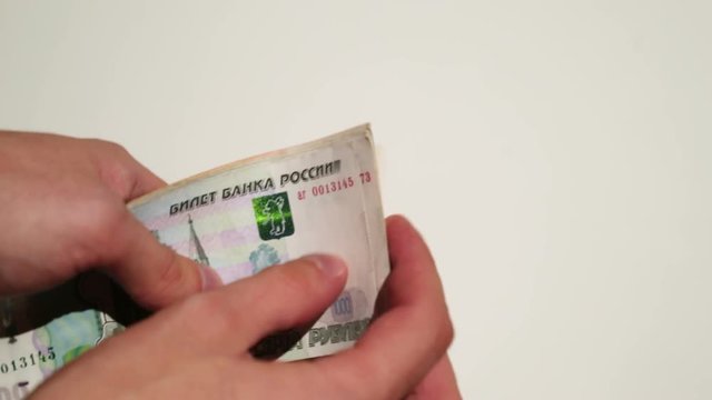 Unrecognizable person counting russian roubles money closeup