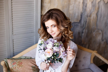 Young attractive Girl in Bathrobe by the window