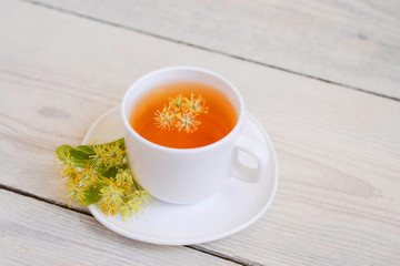 linden tea in a white cup on a light background, 