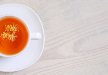 linden tea in a white cup on a light background, 