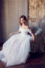 Fototapeta premium Bride in a beautiful dress near the window