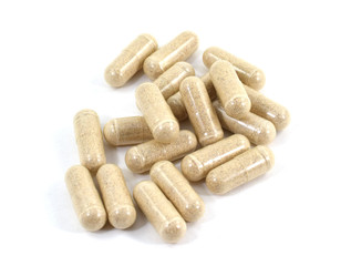 Drug capsule pills with beige medication in pile