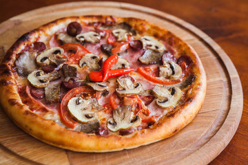 Delicious pizza with chili mushrooms and sausages