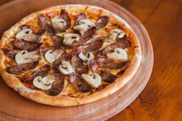 Delicious pizza with chili mushrooms and sausages