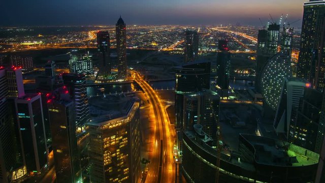 Fantastic nighttime skyline of downtown Dubai. Scenic aerial view of highway and skyscrapers.. 4K time lapse. Travel background.