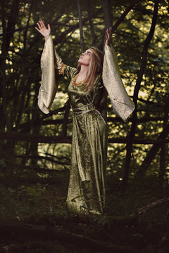 Forest woman with arms to the sky