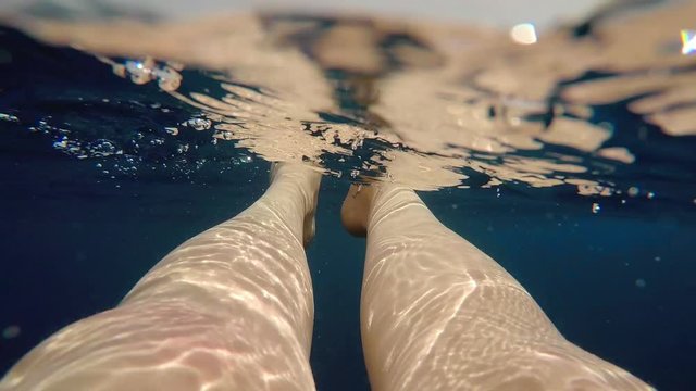 Beautiful womans feet swimming underwater on paradise beach freedom wellbeing lifestyle summer vacation wanderlust 