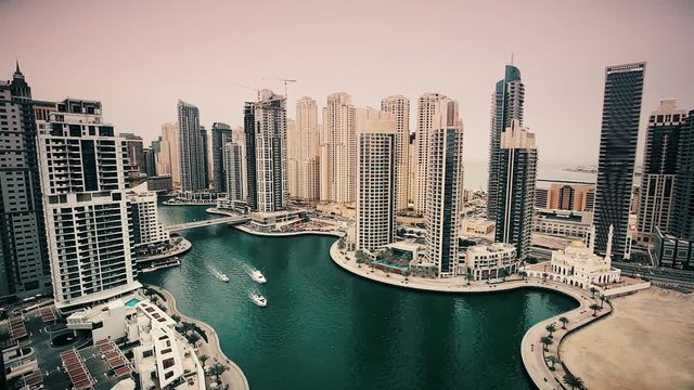 Spectacular daytime skyline of Marina district in Dubai, UAE. Creek view with sailing boats and skyscrapers. Popular travel destination. Time lapse.