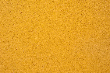 Texture of a textured yellow wall