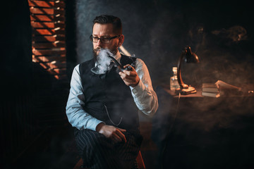 Portrait of man sitting on chair and smoking pipe
