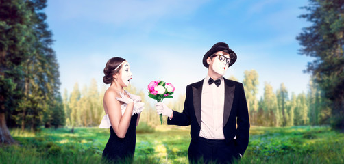 Mime actors performing with flower bouquet