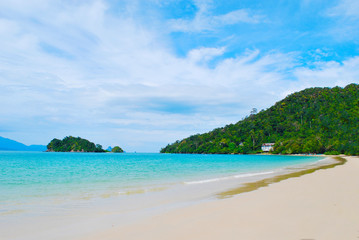 Plakat View from a beach in a tropical island, Langkawi in Malaysia : blue sky, blue water and sand.