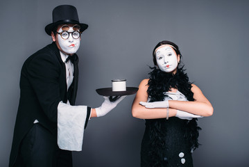 Mime actors performing with a glass of water