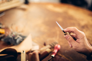 Obraz premium leather craftsman working making products at table in workshop studio