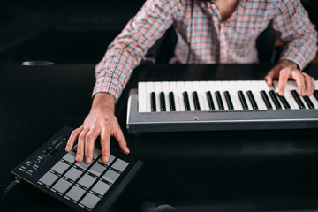Fototapeta na wymiar Male sound producer hands on musical keyboard