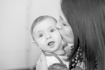 Child 6 months old and smiling at home on a blue blanket of the starry sky