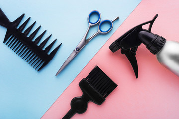 Hairdresser set with various accessories on pink and blue background